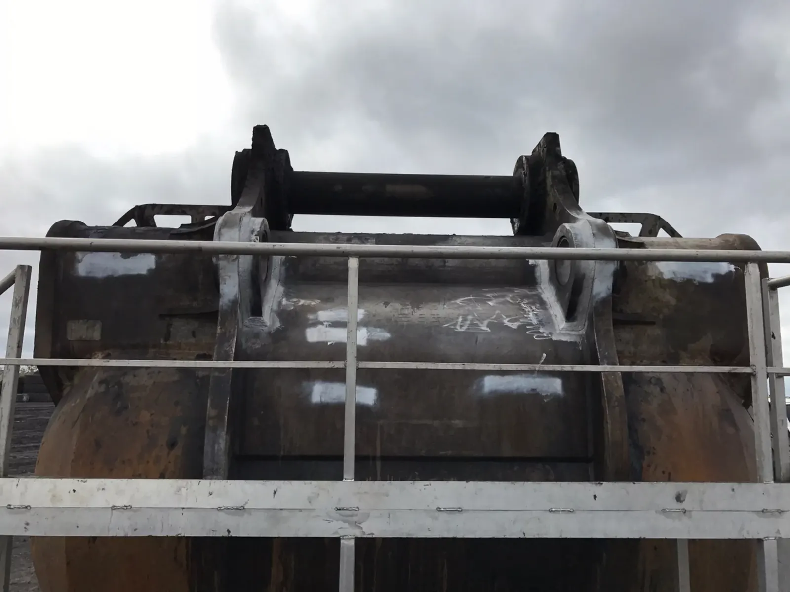 Large bucket with treated welds at the attachment brackets