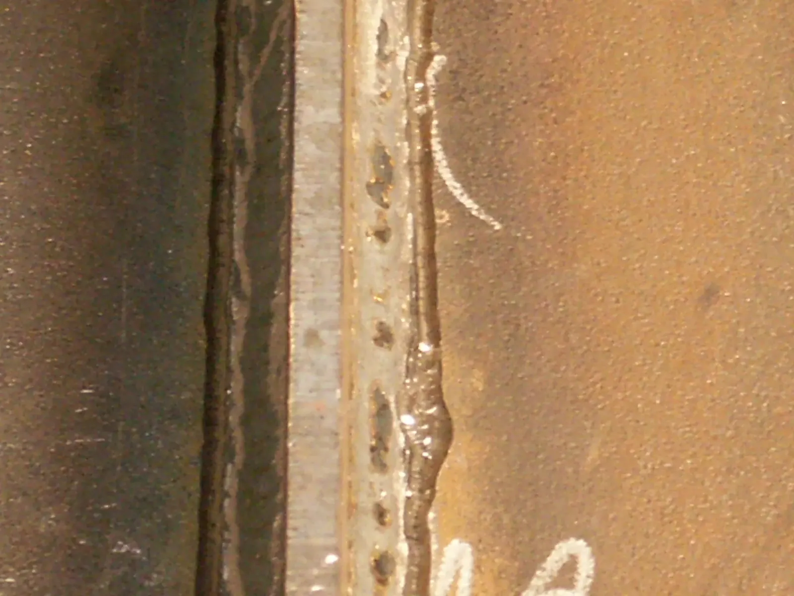 Close-up of a treated weld toe with the HFMI groove visible