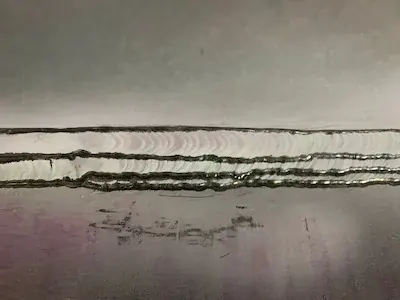 Multi-pass weld with treated weld toes
